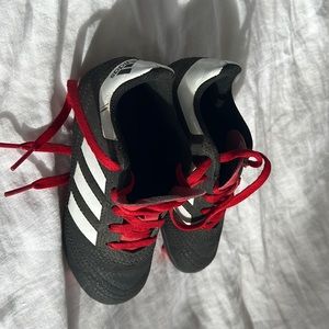 Adidas kids spikes.  Black with a little red and white toddler size 10